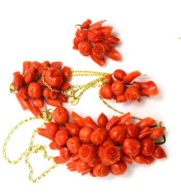 Lot 183 - Two coral pendants and a pair of earrings, in fruit and flower form (a.f.)