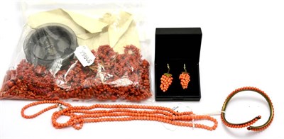 Lot 201 - A coral bangle, a coral necklace, a pair of coral earrings in the form of a bunch of grapes,...