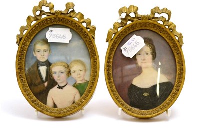 Lot 265 - A pair of early Victorian oval family portrait miniatures on ivory, giltwood frames