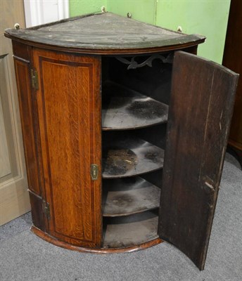 Lot 1191 - Georgian oak and mahogany crossbanded hanging corner cabinet