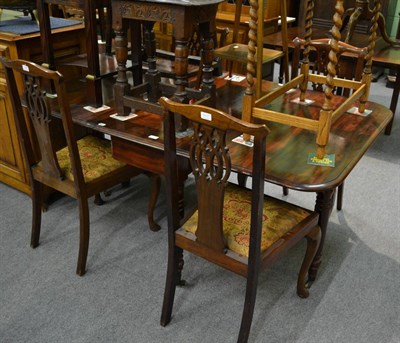 Lot 1205 - A Victorian mahogany drop leaf dining table raised on brass casters, together with four...