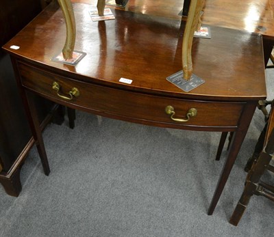 Lot 1213 - A George III mahogany bowfront writing table, with single frieze drawer with swan neck drop...