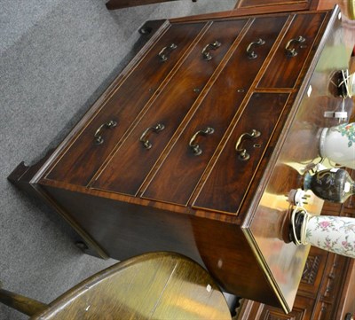 Lot 1232 - A George III mahogany straight front chest of two short over three long drawers, raised on...