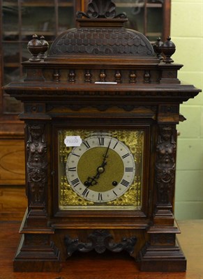 Lot 1235 - A carved oak mantel clock with square brass dial