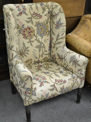 Lot 1239 - A 19th century wing armchair, with crewelwork upholstery (later re-covered)