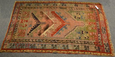 Lot 1247 - An Anatolian prayer rug, the field with polychrome stepped multiple Mihrab enclosed by stylised...