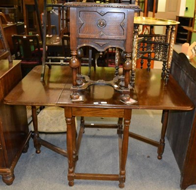 Lot 1261 - An oak drop leaf table and an oak work table with hinged cover and stretcher base