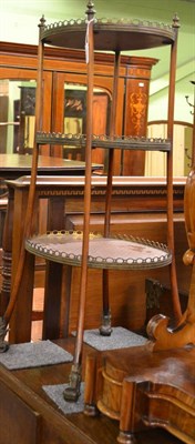 Lot 1280 - A late 19th century French mahogany and parquetry decorated three tier etagere, of circular...