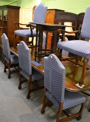 Lot 1285 - A modern oak and elm dining table together with eight upholstered chairs and matching sideboard