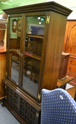 Lot 1286 - A modern oak glazed bookcase on cupboard base