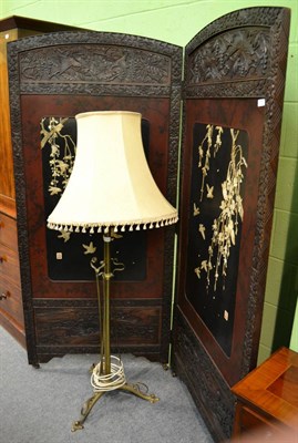 Lot 1295 - A Chinese ebonised and carved two fold screen with ivory mounts