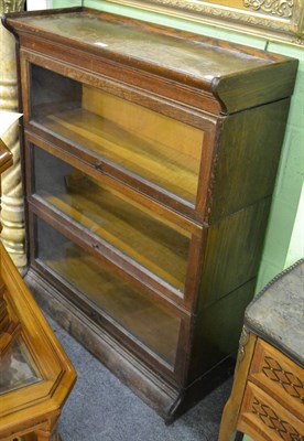 Lot 1304 - An early 20th century Globe Wernicke style oak three section bookcase, with pivoting glass doors