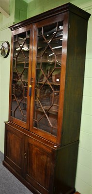 Lot 1324 - A 19th century mahogany glazed bookcase on base