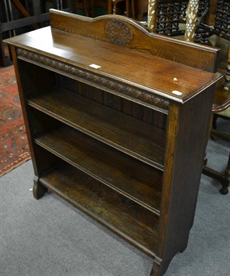 Lot 1331 - A 1920s oak bookcase with two shelves raised on bracket feet