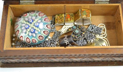 Lot 11 - A millefiori glass paperweight and a small quantity of costume jewellery in a carved box