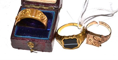 Lot 20 - A buckle ring, a locket ring and a sardonyx set signet ring