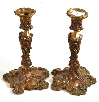 Lot 55 - A pair of French bronze Rococo candlesticks
