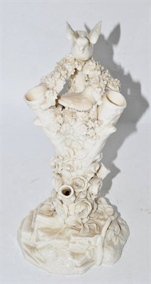Lot 58 - Belleek porcelain posy vase, naturalistically modelled as a tree trunk with a bird sat in a...