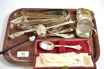 Lot 60 - A collection of assorted silver and white metal including serving tongs, cake slice, trefid...