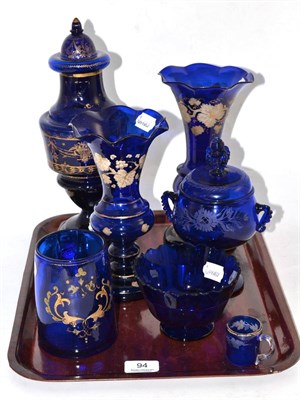 Lot 94 - Collection of blue glassware including gilt decorated urn vase and cover