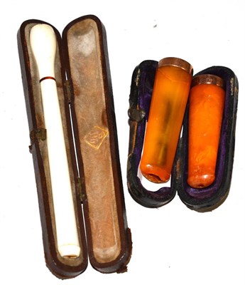 Lot 167 - Ivory cheroot holder and two amber cigar holders with gold mounts, circa 1900