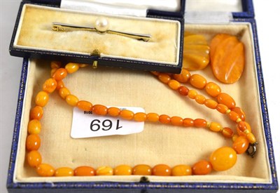 Lot 169 - Amber bead necklace, two other pieces of amber and a bar brooch mounted with a cultured pearl