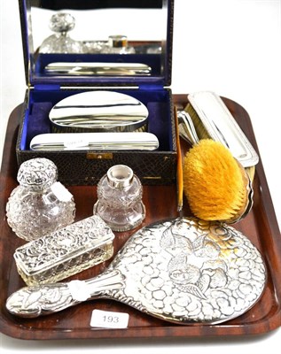 Lot 193 - A silver hand mirror, cased brush set, two brushes, a comb, two scents and a box