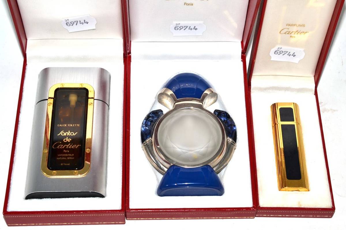 Lot 240 - Three Cartier perfume bottles, cased