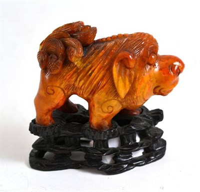 Lot 268 - An amber figure of a lion dog