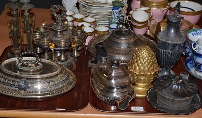 Lot 285 - Two trays including a silver plated egg cruet, two pairs of Regency style candlesticks, etc