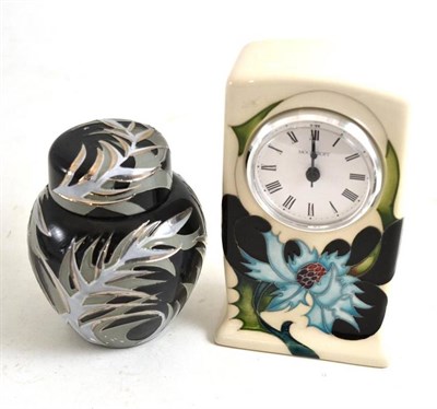 Lot 306 - A modern Moorcroft clock and a modern Moorcroft ginger jar and cover, numbered 23/75