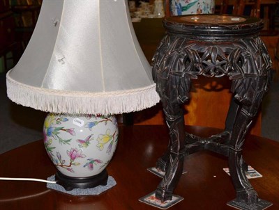 Lot 320 - Chinese hardwood stand and a reproduction lamp
