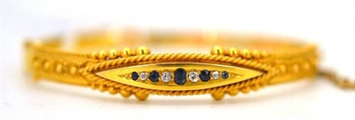 Lot 332 - A sapphire and diamond bangle, stamped '15.625' (previous repairs)