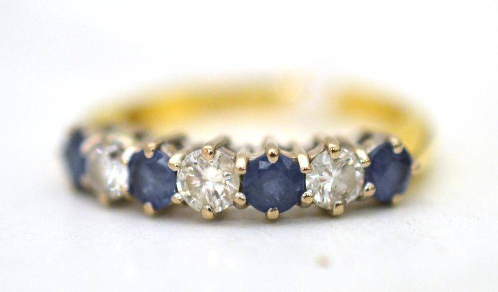 Lot 344 - An 18ct gold sapphire and diamond seven stone ring