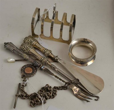 Lot 372 - Silver toast rack, silver watch chain, silver napkin ring, etc