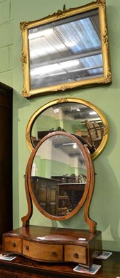 Lot 512 - A mahogany serpentine dressing mirror and two gilt wall mirrors