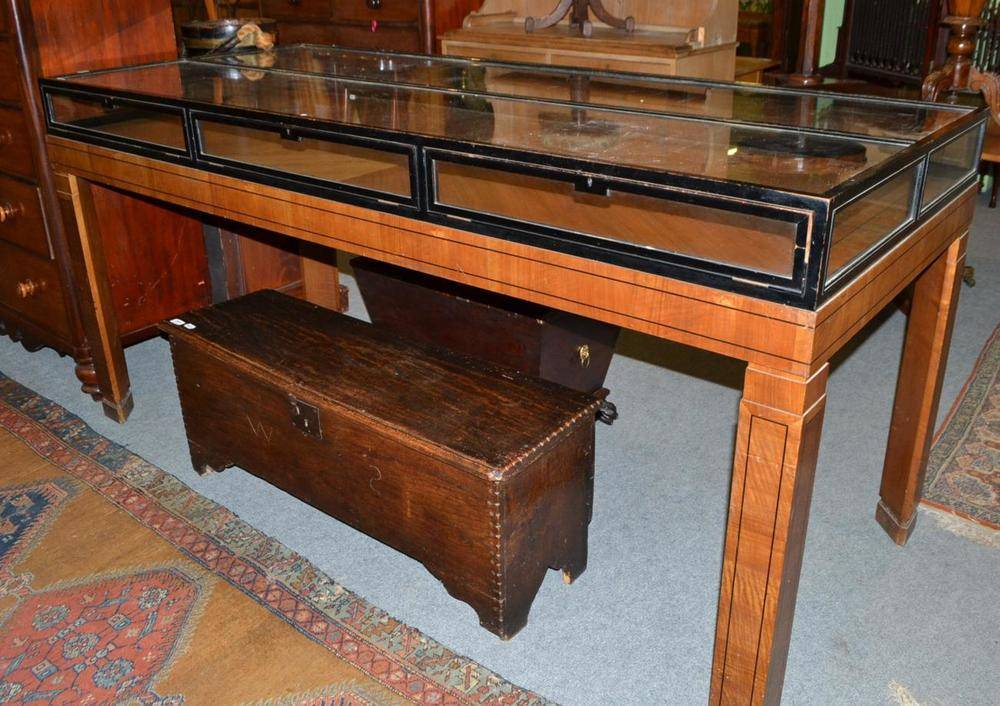 Lot 597 - Walnut and ebonised display table fitted
