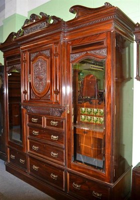 Lot 621 - Victorian carved mahogany triple wardrobe