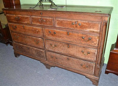 Lot 645 - An 18th century oak dresser base with dummy drawers and hinged top