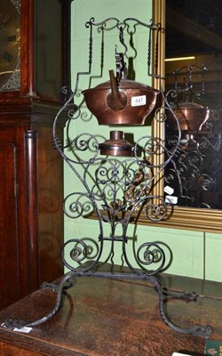 Lot 647 - An Arts & Crafts copper spirit kettle on a wrought iron stand