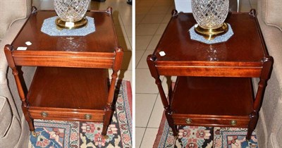 Lot 659 - A pair of modern mahogany two tier occasional table with drawer and brass casters