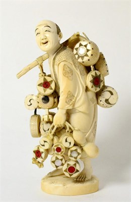 Lot 142 - A Japanese Ivory Okimono, Meiji period (1868-1912), as a drum seller carrying drums suspended...