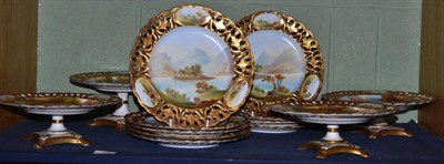 Lot 48 - A Staffordshire porcelain dessert service, painted with landscapes within gilt pierced borders