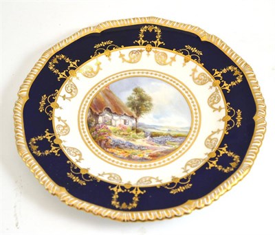 Lot 110 - A Royal Crown Derby plate, depicting a cottage scene