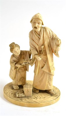 Lot 115 - A good Japanese carved ivory okimono of a figure and attendant, signed to base, circa 1910