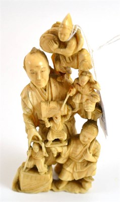 Lot 122 - A Japanese one piece ivory carving/okimono of a group of figures, circa 1900 (re-glued)