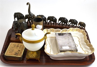 Lot 161 - EPBN sandwich box, two carved and stained wooden elephant trains, 1941 gun cartridge, tin of...