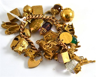 Lot 206 - A charm bracelet hung with twenty-five charms