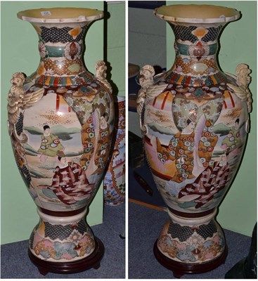 Lot 234 - A pair of large Japanese earthenware vases, 94cm high, and two wood stands