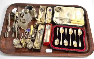 Lot 258 - A tray including Scottish silver sugar tongs, silver cased spoons, silver and enamelled spoons, etc